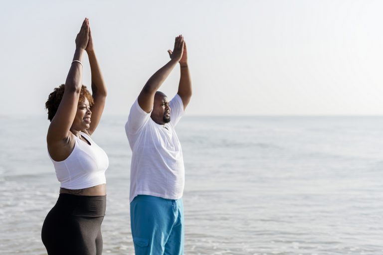 african-american-couple-working-out-at-the-beach-3WH8BU6-768x512