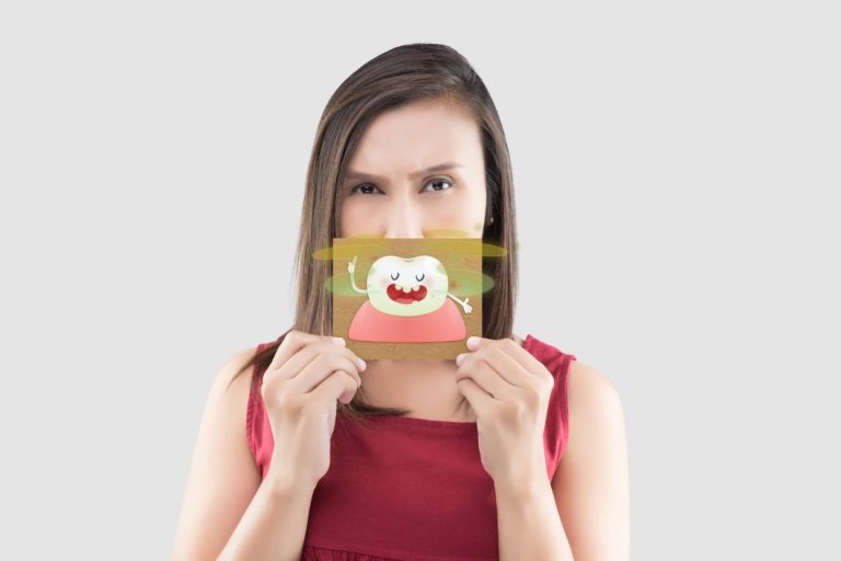 asian-woman-in-the-red-shirt-holding-a-brown-paper-with-the-yellow-teeth-cartoon-picture-of-his-mouth_t20_4bglGX-768x512