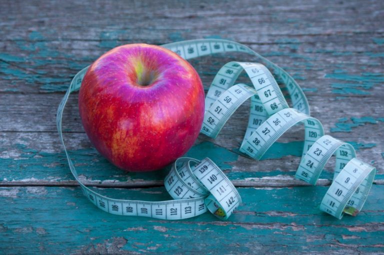 d-apple-wrapped-in-inch-tape-on-blue-color-background-inch-weight-healthy-eating-vegan-fat-food_t20_1b8aV1-768x510