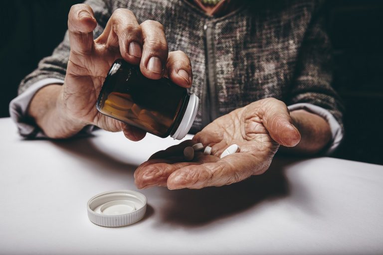elderly-woman-taking-prescription-medicine-P2QLTPN-768x512