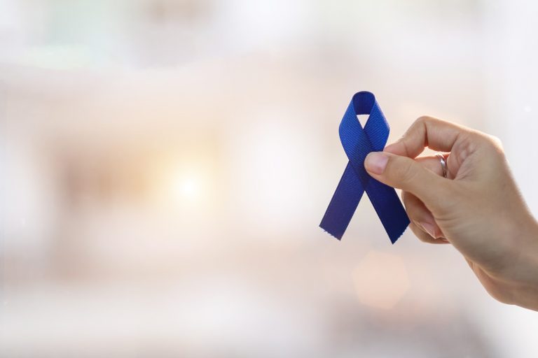 march-colorectal-cancer-awareness-month-man-holding-dark-blue-ribbon-for-supporting-people-living-and_t20_Nx8B07-768x512