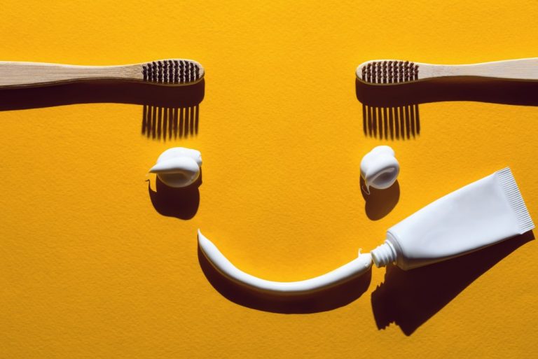 wooden-toothbrushes-and-pasta-on-a-yellow-background-dental-concept-in-the-form-of-a-funny-face-smile_t20_VWrn7k-768x513