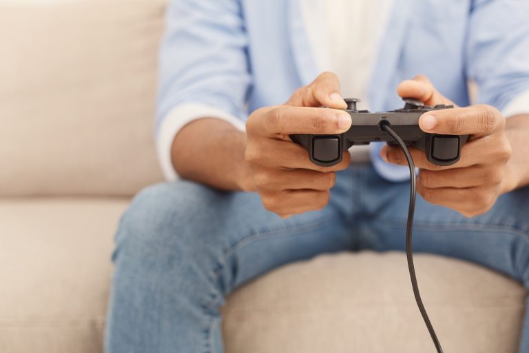 young-man-playing-video-games-at-home-SR9PV3L-768x512